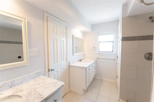 a spacious bathroom with a bathtub sink and mirror
