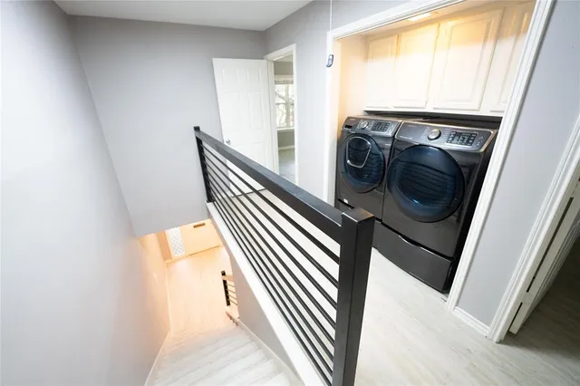 a view of a hallway with washer and dryer