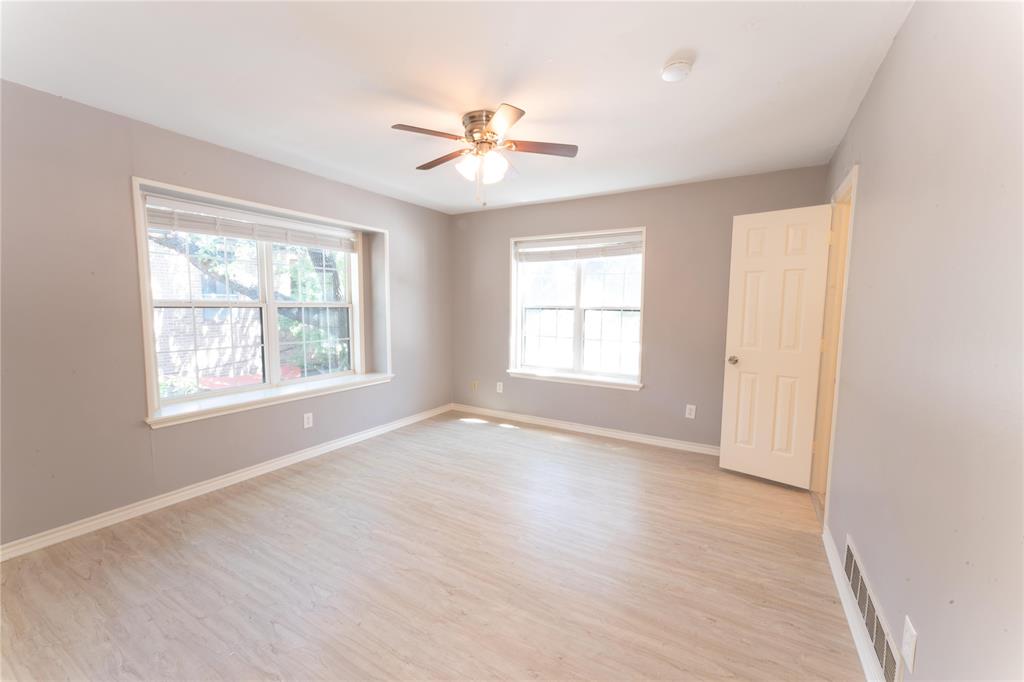 6509 Preston Road, Unit 1 University Park, TX 75205 - Photo 7 of 15 a view of an empty room with a window and wooden floor