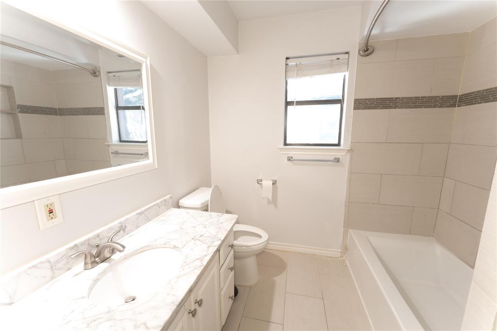 6509 Preston Road, Unit 1 University Park, TX 75205 - Photo 8 of 15 a bathroom with a granite countertop sink a toilet and bathtub