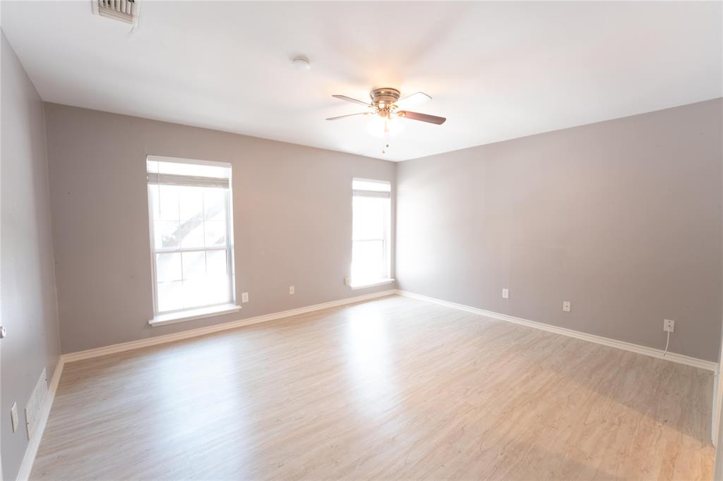 6509 Preston Road, Unit 1 University Park, TX 75205 - Photo 9 of 15 an empty room with wooden floor and windows