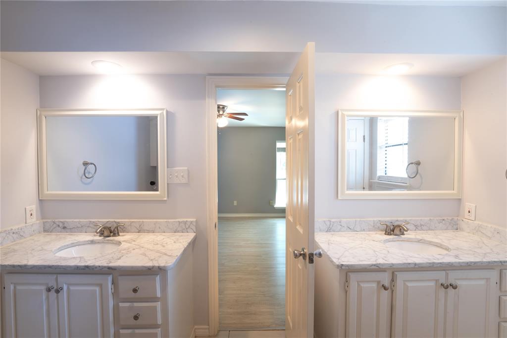 6509 Preston Road, Unit 1 University Park, TX 75205 - Photo 10 of 15 a bathroom with a granite countertop sink and a mirror
