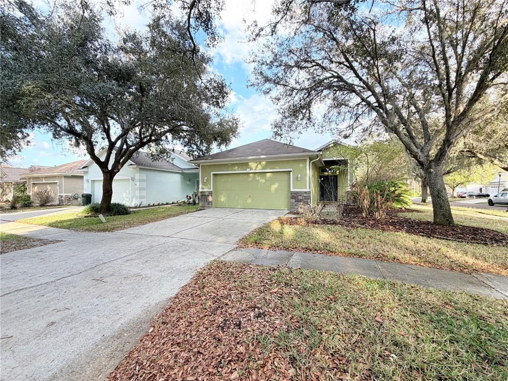5634 Tanagerlake Road Lithia, FL 33547 - Photo 2 of 46 a front view of a house with a yard and garage