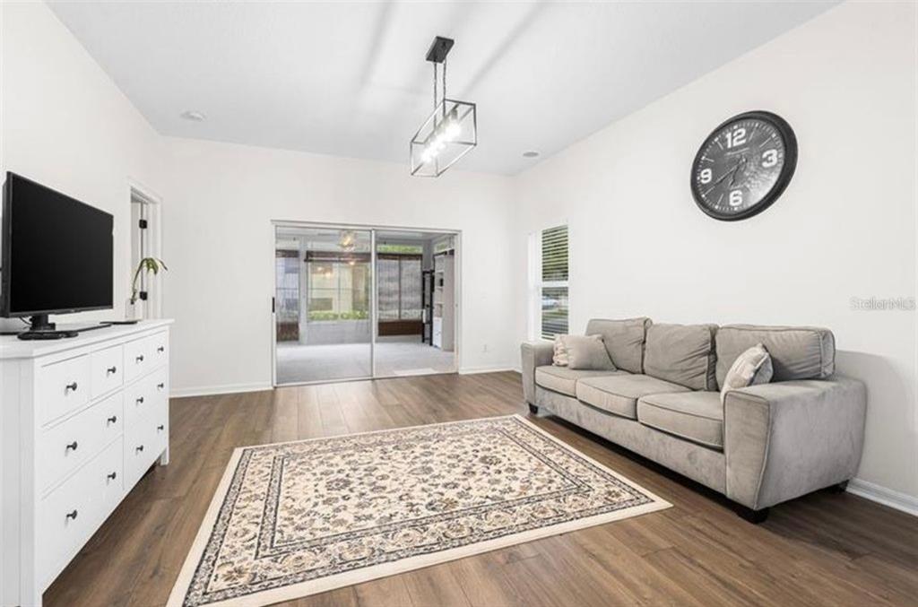 5634 Tanagerlake Road Lithia, FL 33547 - Photo 2 of 4 a living room with furniture and a flat screen tv