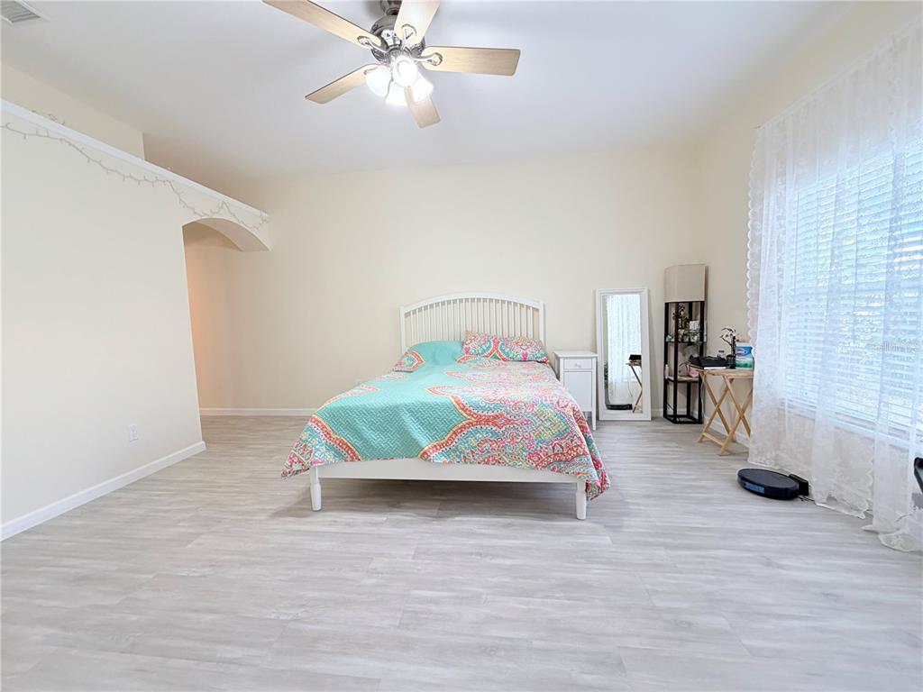5634 Tanagerlake Road Lithia, FL 33547 - Photo 23 of 46 a bedroom with a bed and a chandelier