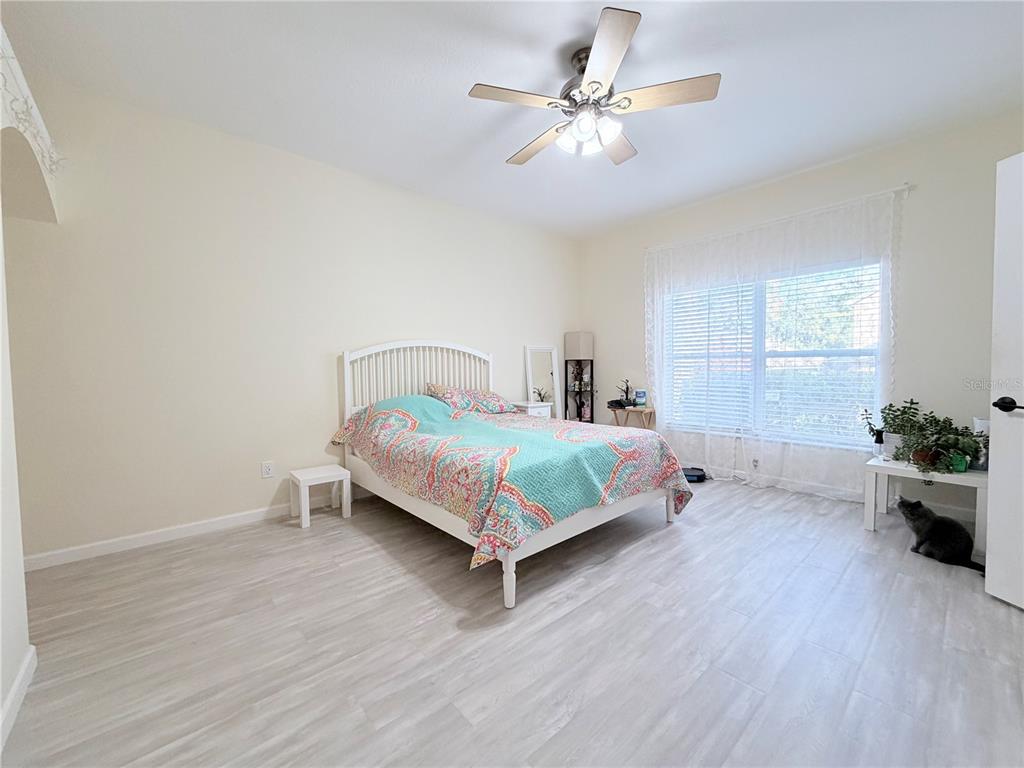 5634 Tanagerlake Road Lithia, FL 33547 - Photo 26 of 46 a bedroom with a bed chandelier and a window
