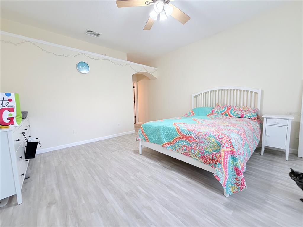 5634 Tanagerlake Road Lithia, FL 33547 - Photo 27 of 46 a bedroom with a bed and a chandelier