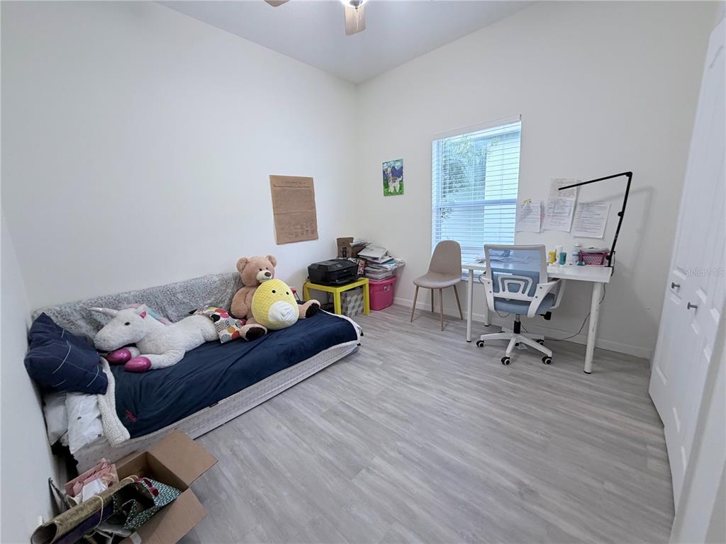 5634 Tanagerlake Road Lithia, FL 33547 - Photo 35 of 46 a living room with furniture and a wooden floor