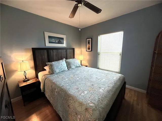 a bedroom with a bed and flat screen tv