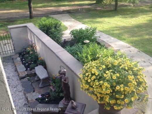 511 Cerrina Road Jackson, NJ 08527 - Photo 2 of 46 a view of a garden with plants and a fountain