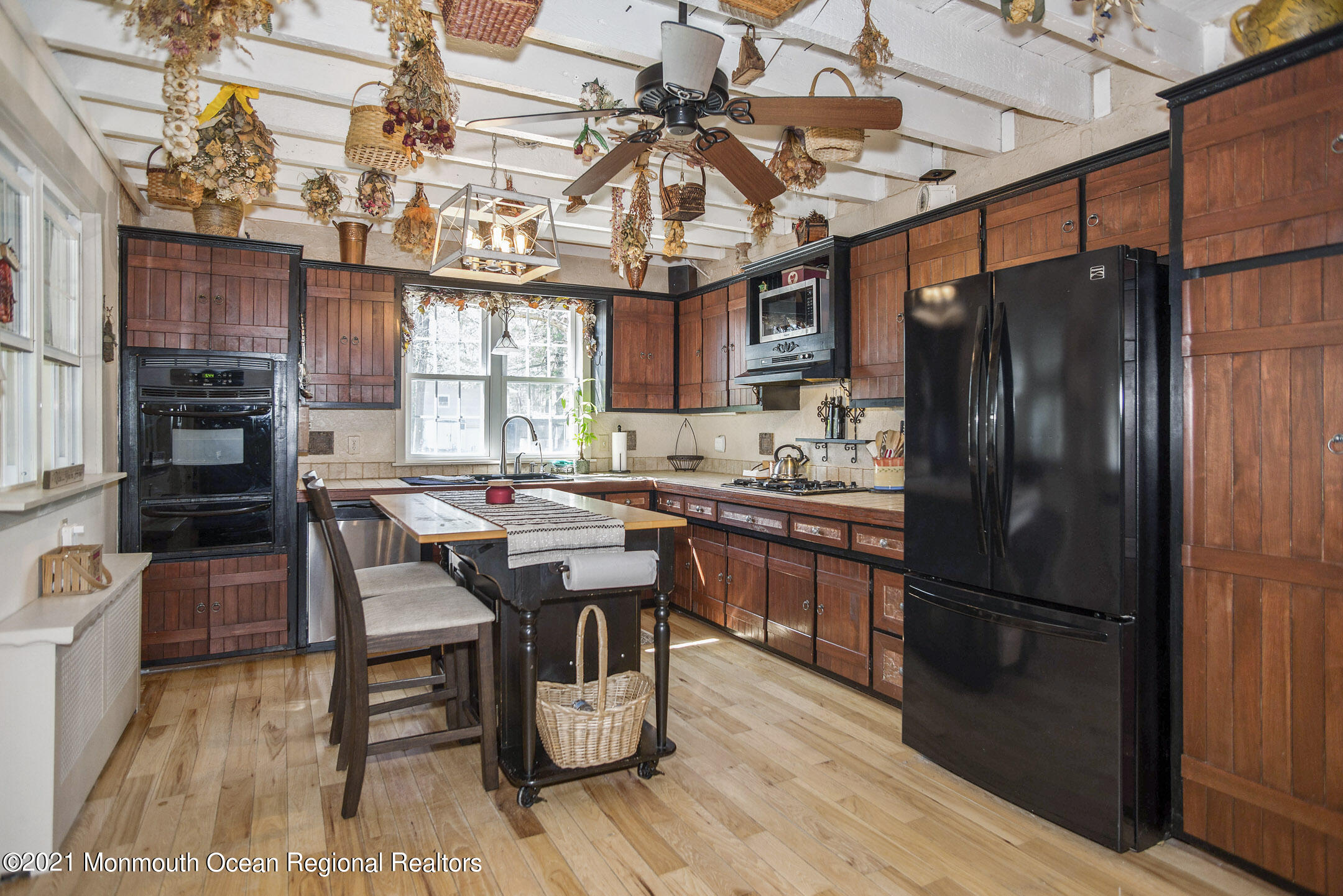 511 Cerrina Road Jackson, NJ 08527 - Photo 15 of 46 a kitchen with stainless steel appliances granite countertop a refrigerator a stove a sink dishwasher a dining table and chairs with wooden floor