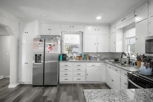 a kitchen with stainless steel appliances a refrigerator sink and cabinets