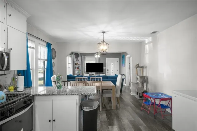 a kitchen with sink cabinets and dining table