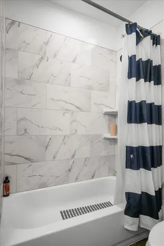 a bathroom with a bathtub and a shower