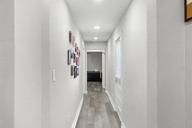 a view of a hallway with wooden shelves
