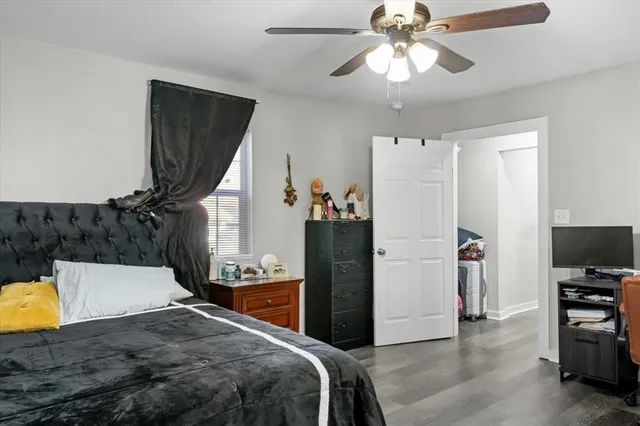 a bedroom with bed and wooden floor