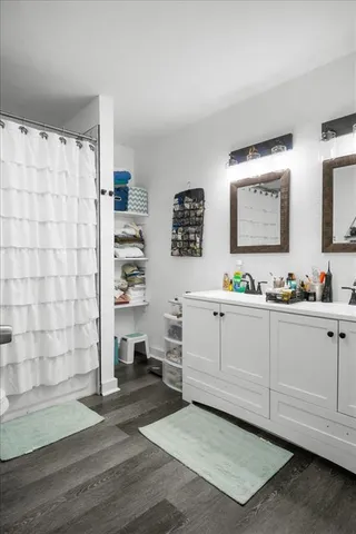 a bathroom with a sink a toilet and shower curtain