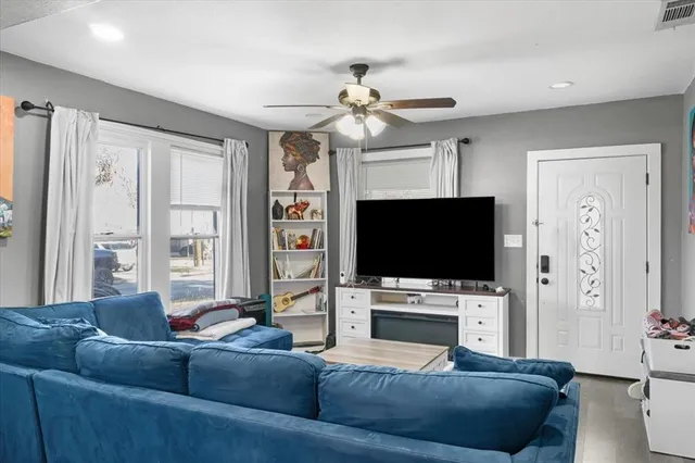 a living room with furniture and a flat screen tv
