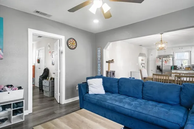 a living room with a couch and a chandelier