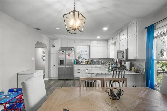 a large kitchen with a table and chairs