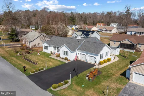 an aerial view of a house with a yard basket ball court and outdoor seating