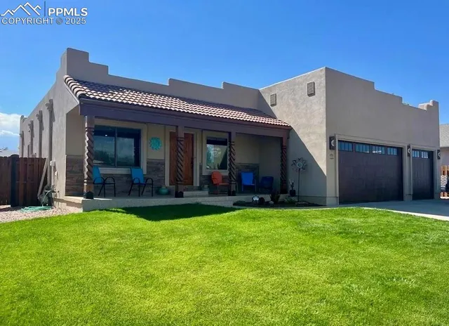 a view of a house with a yard and porch