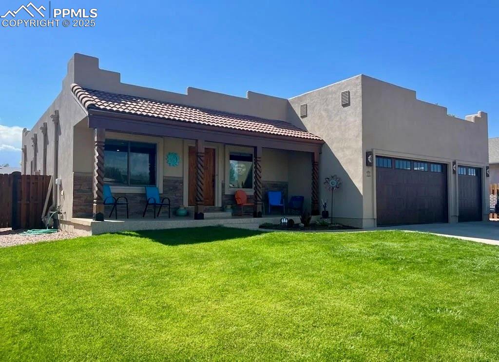 a view of a house with a yard and porch