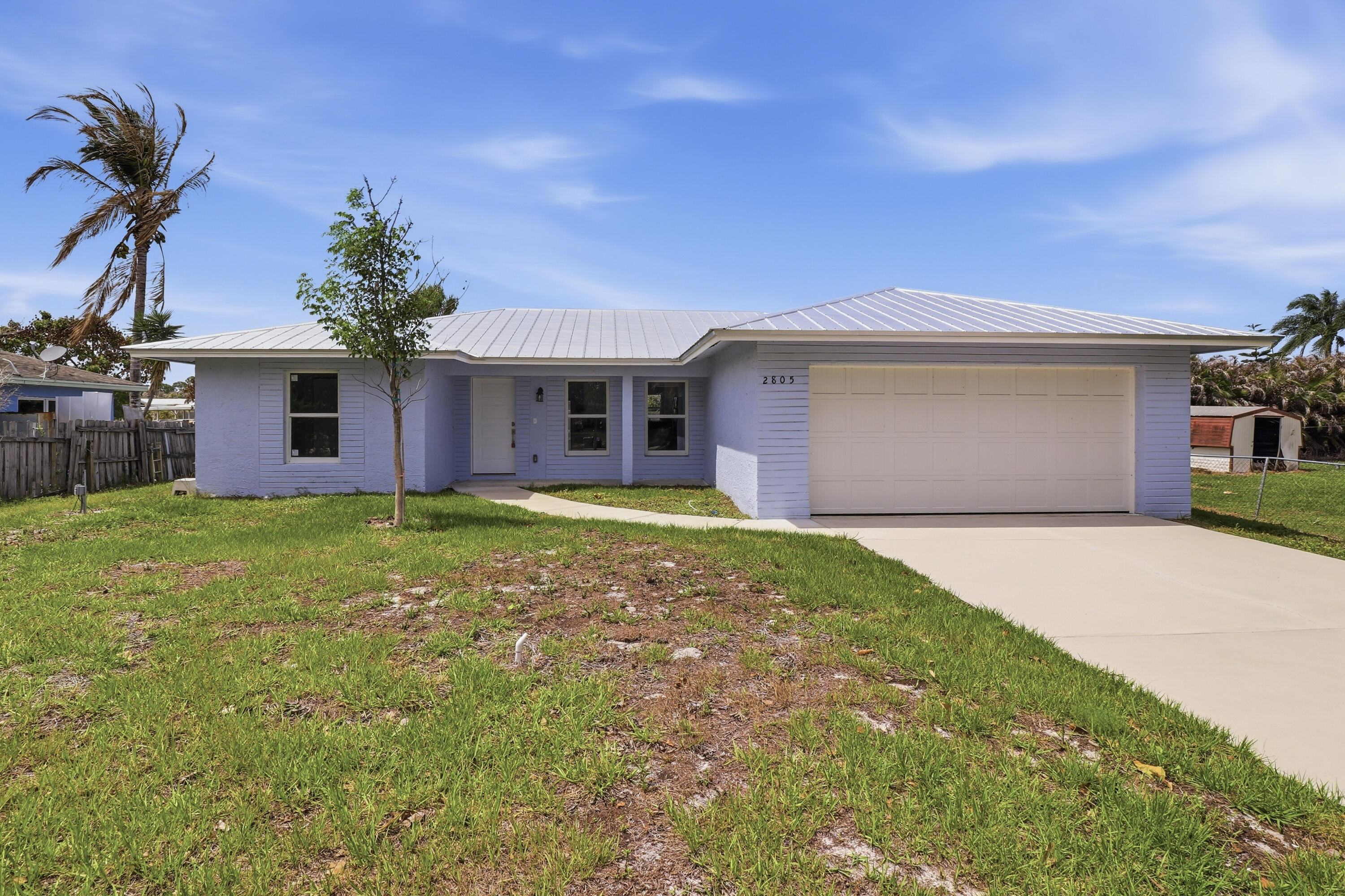 2805 Southeast Carroll Street Stuart, FL 34997 - Photo 1 of 21 a front view of house with yard and trees