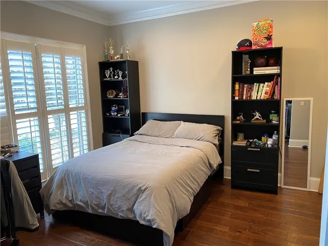 a bedroom with a bed and a bookshelf