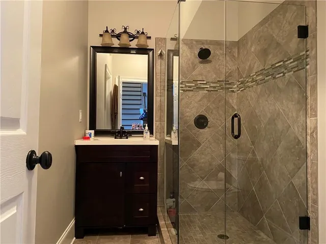 a bathroom with a shower and a sink