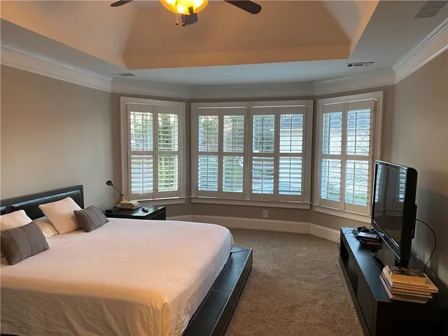 a bedroom with bed and flat screen tv