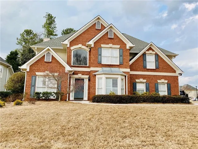 a front view of a house with a yard