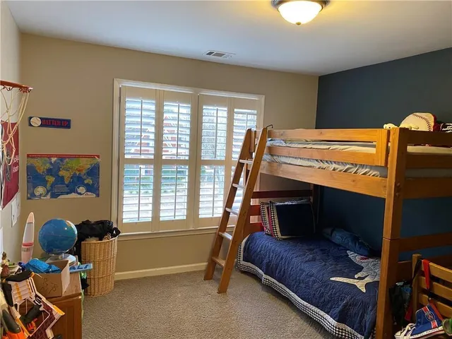 a bedroom with furniture and a window