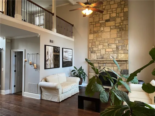 a living room with furniture and a chandelier