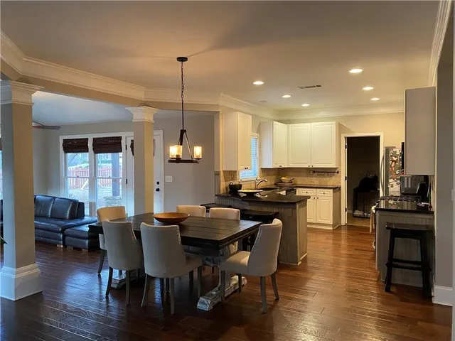 a view of a dining room with furniture wooden floor and chandelier