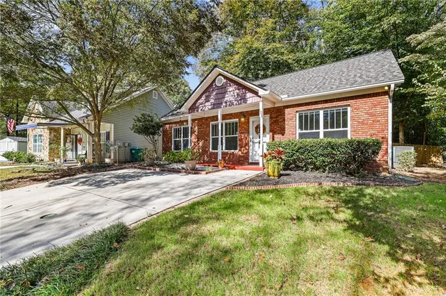 a front view of a house with yard and green space