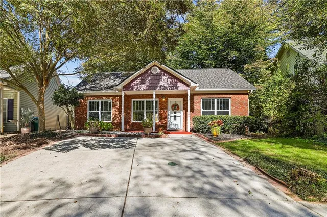 a front view of a house with a garden