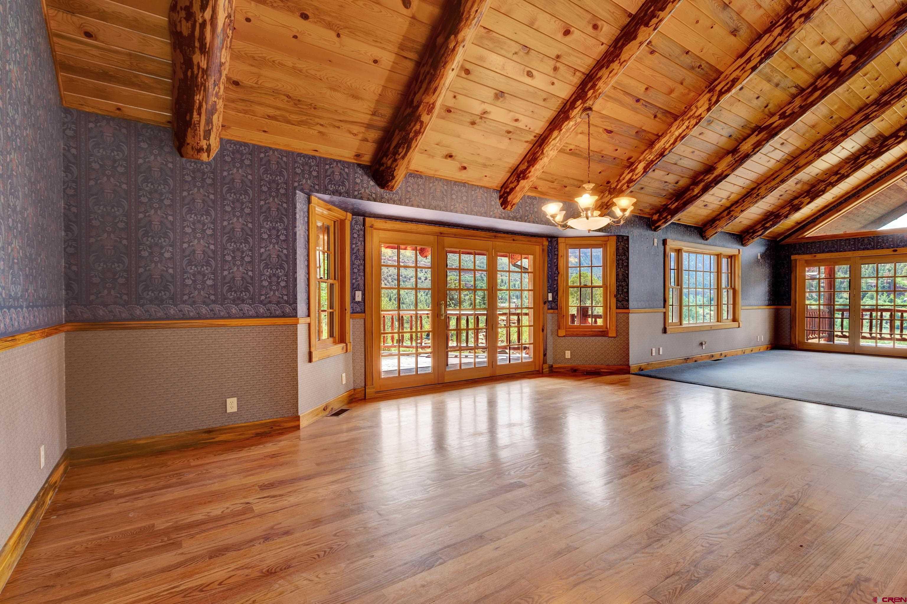 2692 County Road 17 Ridgway, CO 81432 - Photo 5 of 38 a view of an empty room with wooden floor and a window