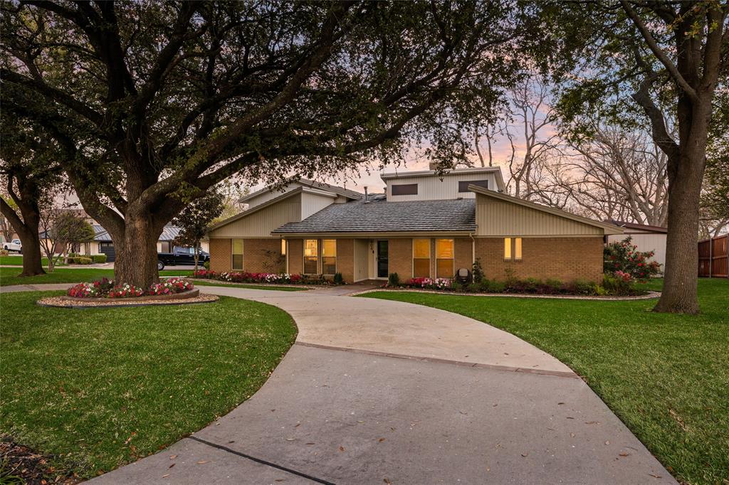 404 Point Royal Drive Rowlett, TX 75087 - Photo 1 of 1 a front view of a house with a yard and trees