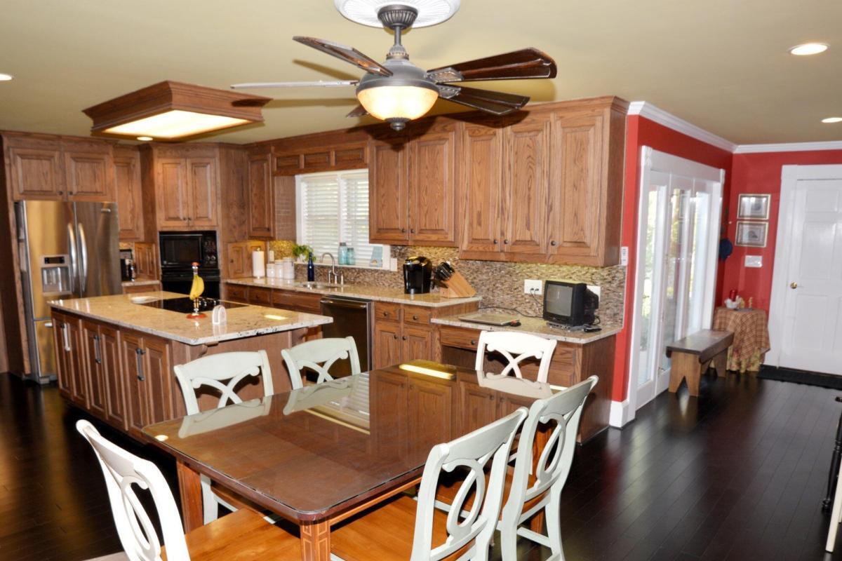 301 Spruill Bridge Road Temple, GA 30179 - Photo 24 of 73 a kitchen with a table chairs stove and microwave