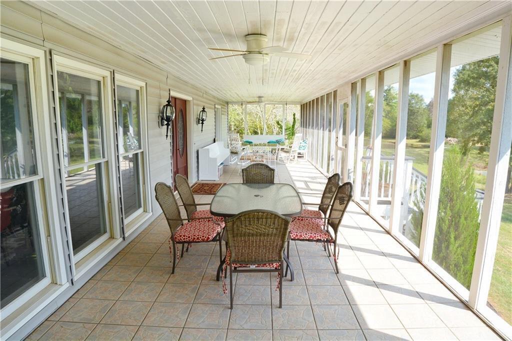 301 Spruill Bridge Road Temple, GA 30179 - Photo 6 of 73 a dining room with furniture a chandelier and glass door
