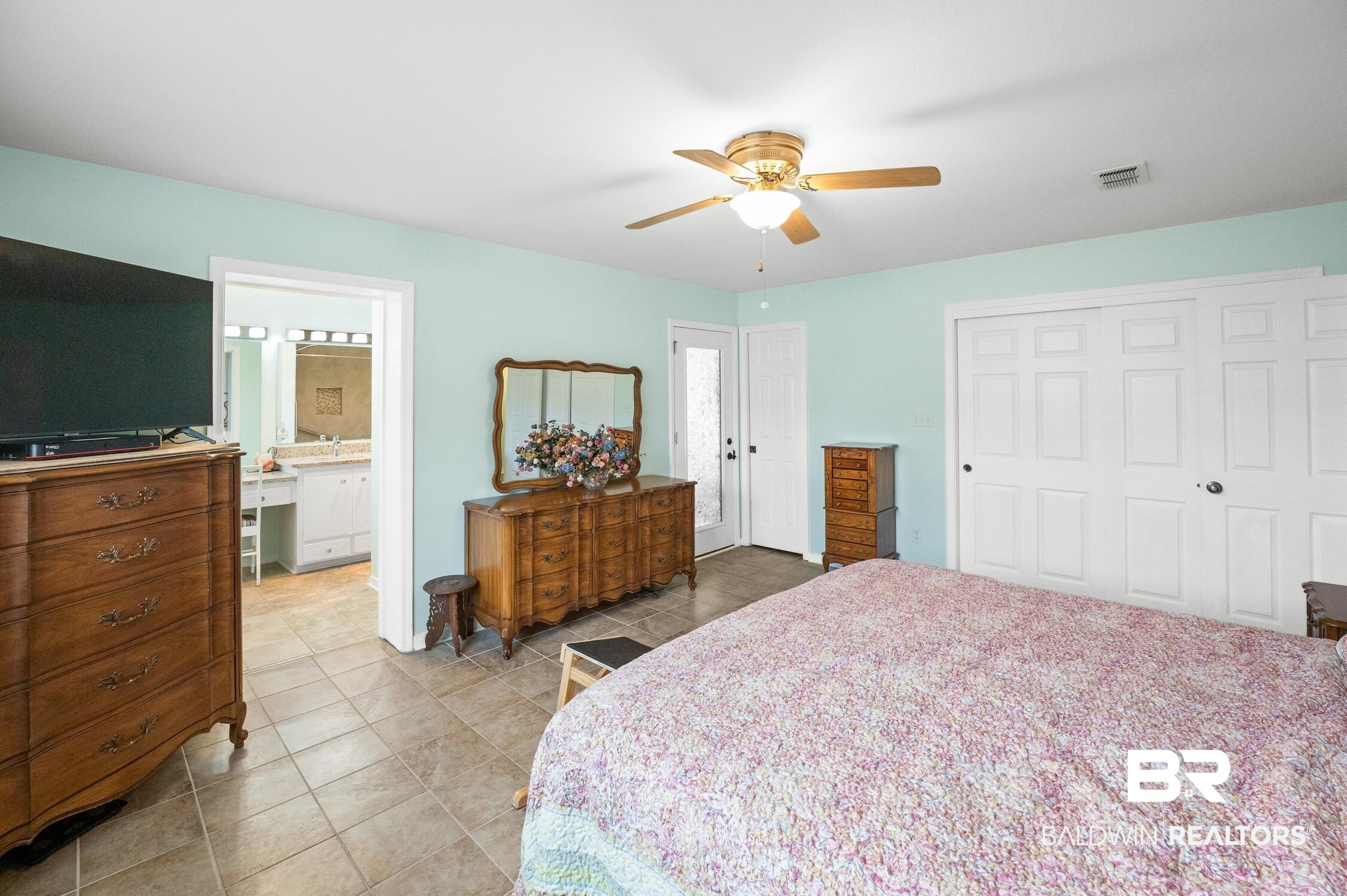 2553 Santa Rosa Drive Lillian, AL 36549 - Photo 25 of 51 Bedroom featuring light tile patterned floors, visible vents, ensuite bath, ceiling fan, and a closet