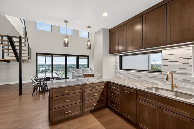 a kitchen with granite countertop wooden cabinets and stainless steel appliances