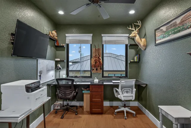 a work room with furniture and a flat screen tv