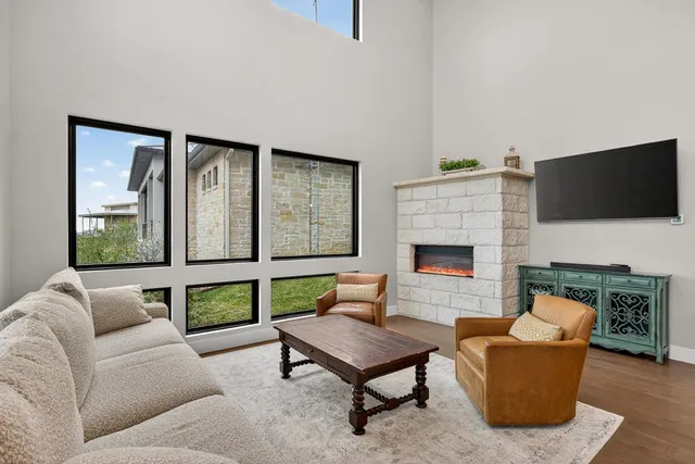 a living room with furniture a flat screen tv and a fireplace