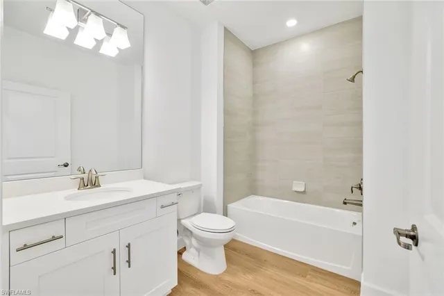 a bathroom with a sink a toilet and bathtub