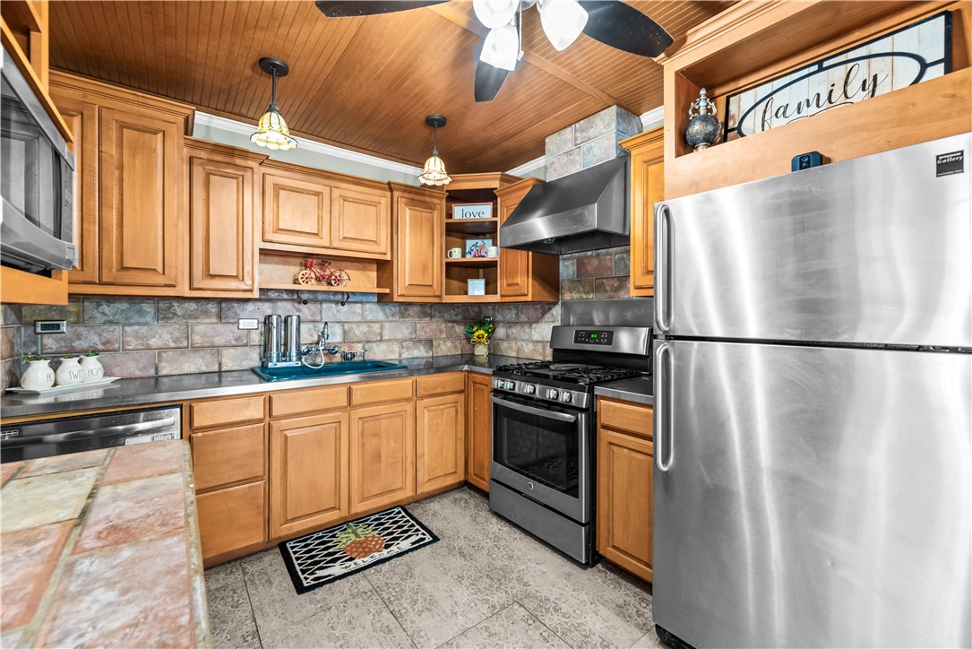 714 Indiana Avenue Corpus Christi, TX 78404 - Photo 12 of 38 a kitchen with stainless steel appliances granite countertop a refrigerator a stove and a sink