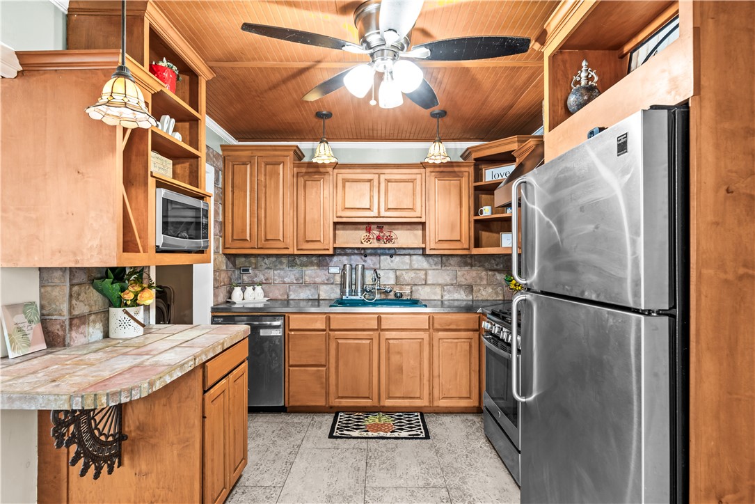 714 Indiana Avenue Corpus Christi, TX 78404 - Photo 14 of 38 a kitchen with stainless steel appliances granite countertop a sink a stove a refrigerator and island