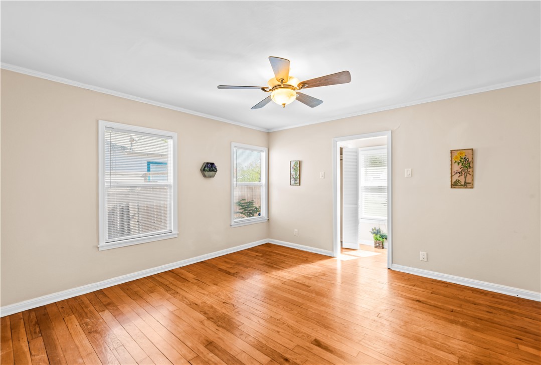 714 Indiana Avenue Corpus Christi, TX 78404 - Photo 20 of 38 a view of empty room with wooden floor and fan