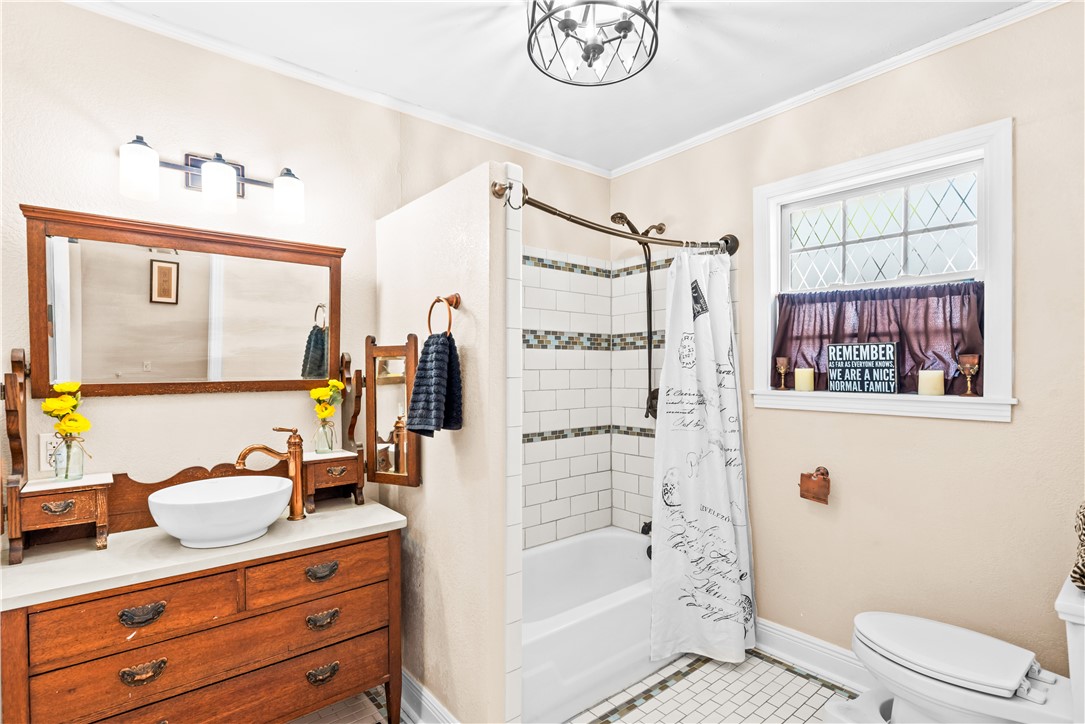 714 Indiana Avenue Corpus Christi, TX 78404 - Photo 28 of 38 a bathroom with a granite countertop sink a mirror a bathtub and a shower